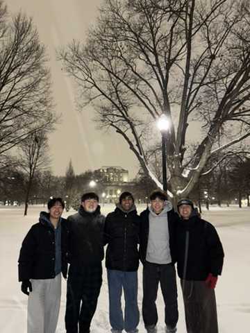 Daniel and friends together outdoors on a snowy evening